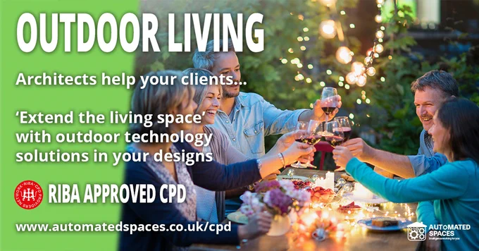 Group of people, toasting glasses of wine, whilst sat at a table outdoors in a garden