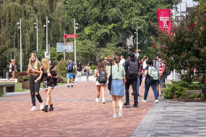 a group of students walking on polett walk