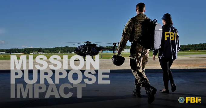 SWAT operator and female special agent in FBI raid jacket walking to a helicopter. "Mission Purpose Impact" FBIJobs