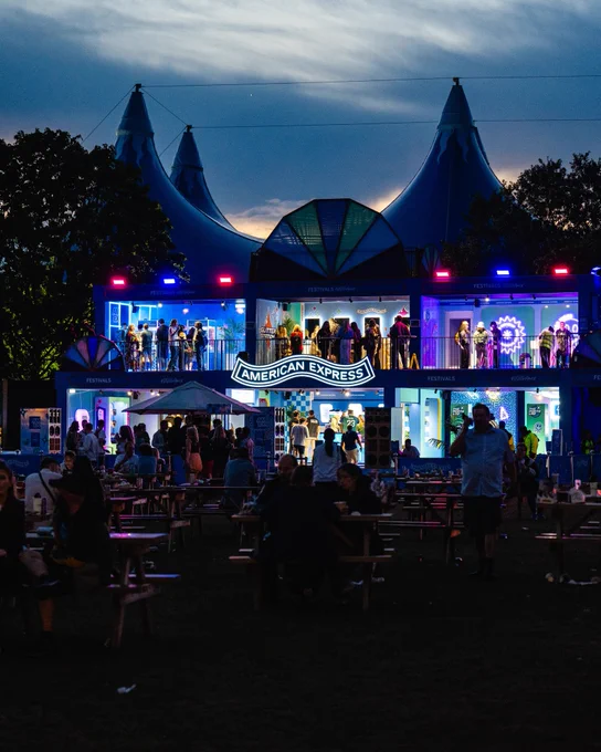 The Amex Experience at All Points East at sunset with blue neon lighting