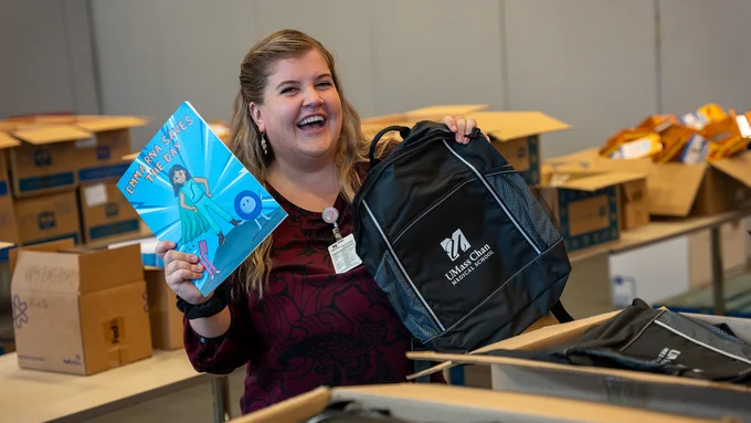 Katie Stickney stuffing a backpack