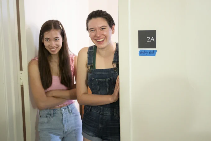 Two people standing in a doorway.