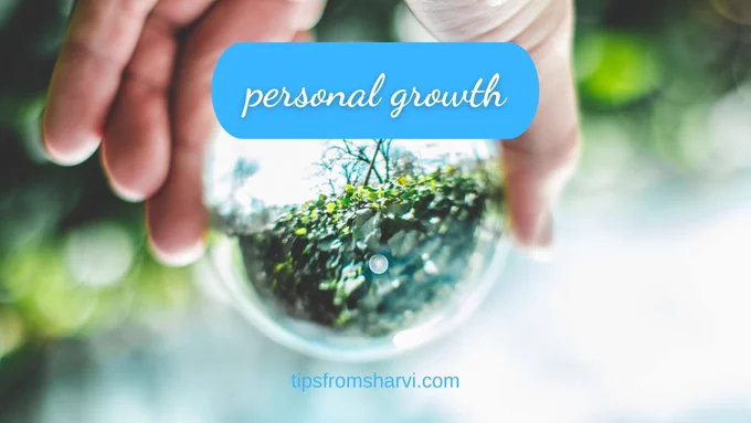 Hand holding a crystal ball with nature.  Text: personal growth, tipsfromsharvi.com.