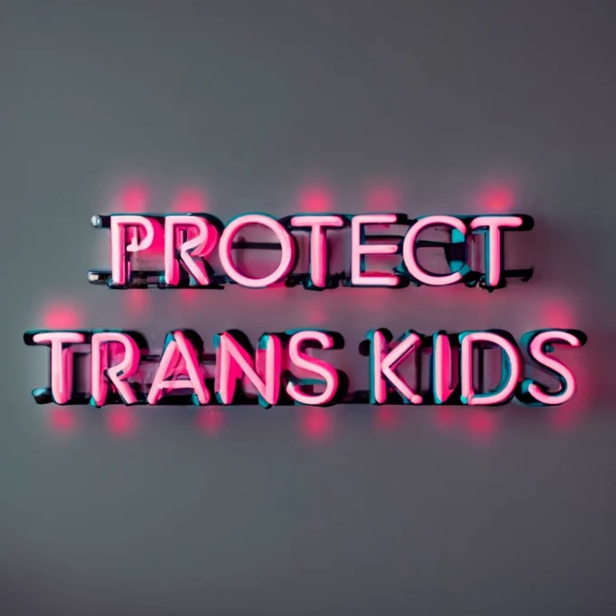 Pink and blue neon sign attached to a wall that reads "protect trans kids"