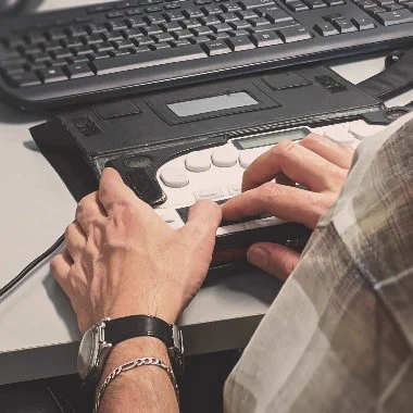 Person using a braille keyboard