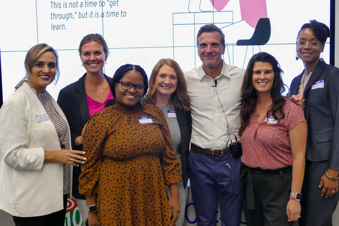 A group of people smile for a photo. 