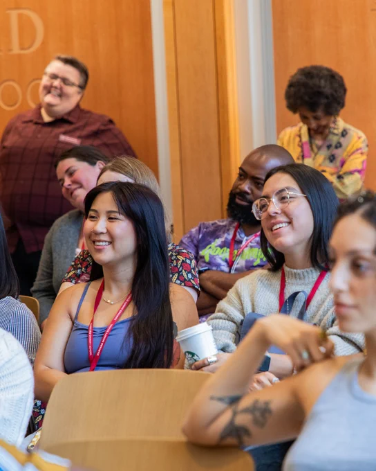 Two students smile at something that was said.