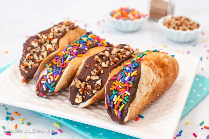A white plate with ice cream filled tortillas.