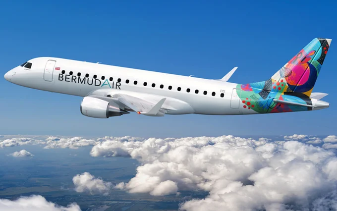 Rendering of BermudAir E175 in-flight above the clouds on a sunny, blue-sky day. The livery features a white fuse with a very colorful tail.