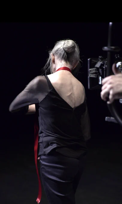 The back of a ballet dancer who is being filmed.