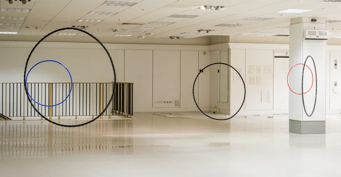 A former shopping centre with large circle sculptures hanging from the ceiling. 