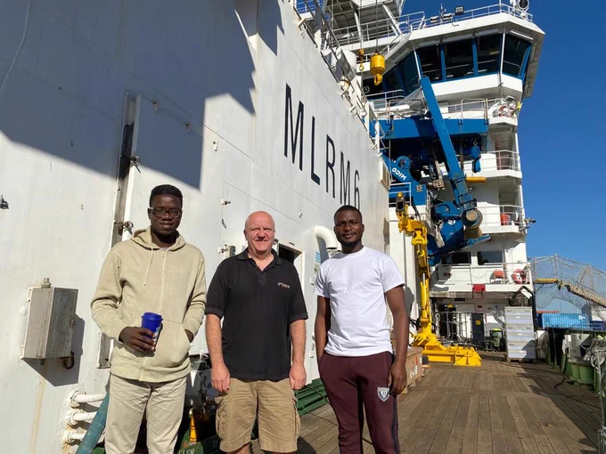 Adeola Dahunsi and Selasi Yao Avornyo, previous recipients of the bursary, with Dr Ben Moat