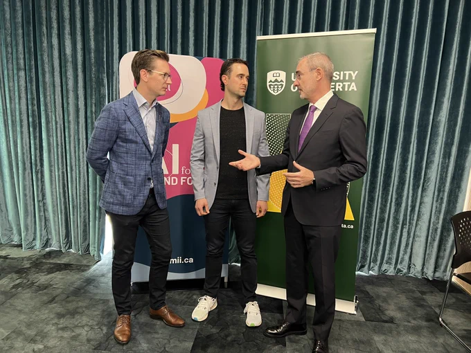 A group photo of Minister Glubish, Cam Linke and President Flanagan talking.