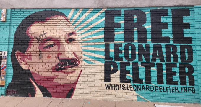 Mural in Albuquerque, New Mexico. Picture of Leonard Peltier with text that says:
Free Leonard Peltier 
whoisleonardpeltier.info