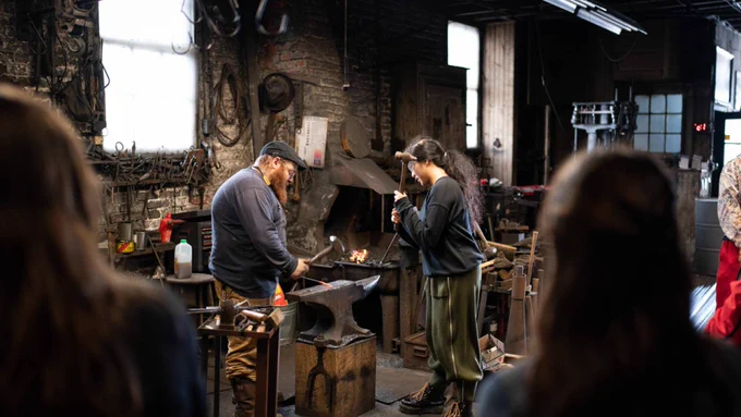 Students work in a forge workshop