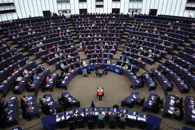 President von der Leyen addressing the European Parliament and standing in the hemicycle. 