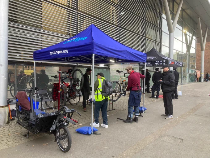 Dr Bike carrying out a bike check under a gazebo