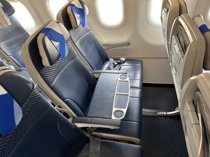 Aegean's EuroBiz-style business class is based on the Collins Meridian platform. Here the blue and beige seats are shown in the classic EuroBiz style, with the middle seat blocked off to provide a table for the aisle and window passengers. The seats are extra spacious with excellent legroom.