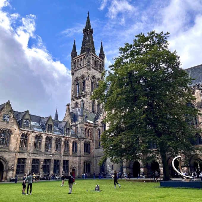 Student societies demonstrating their sports in the East Quad during the Sports Fayre. The UofG Tower can be seen in the background with blue cloudy skies. 