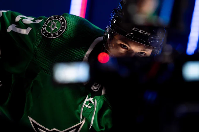 A closeup of Jason Robertson in full uniform with the focus on his eyes looking into a camera