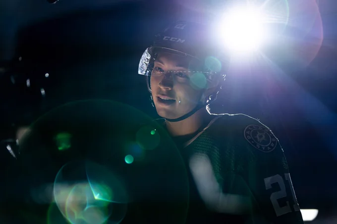 Jason Robertson looking into a camera with a big light flare