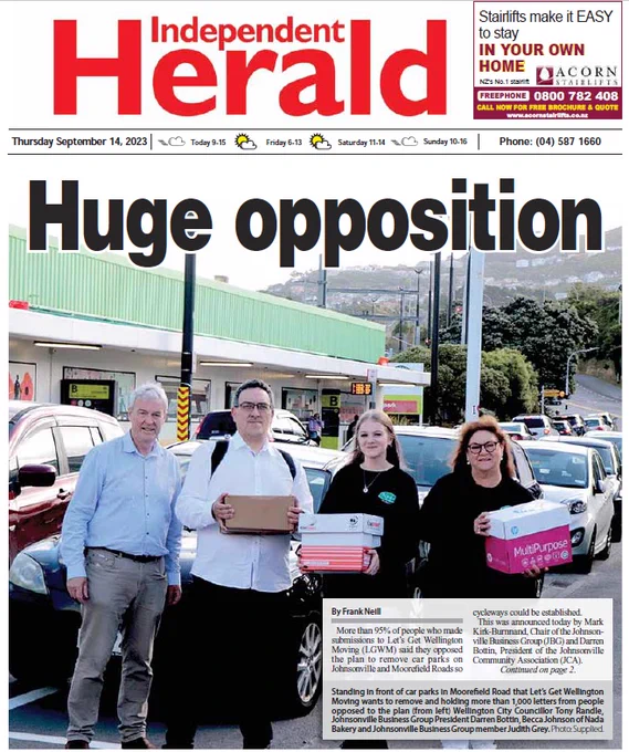 Front Page of the Independent Herald - "Huge Opposition" with photo of boxes of submissions being carried by JCA President Darren Bottin, Becca Johnson of Nada Bakery and Johnsonville Business Group member Judith Grey in front of car parks to be removed. Cr Tony Randle also present.