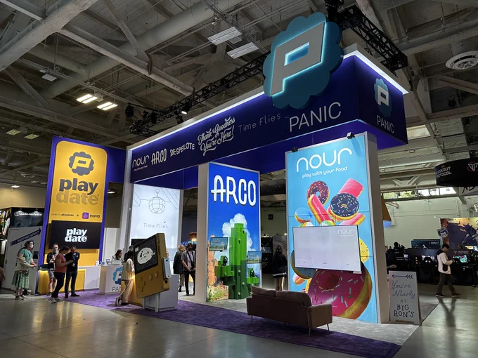 A photo of Panic's PAX West booth. It is sizeable and has multiple stations for different games including Time Flies.