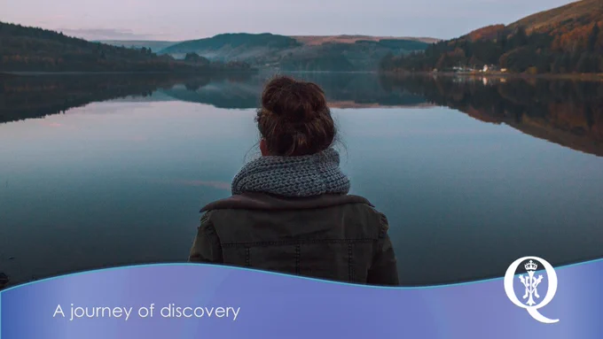 A woman wearing a scarf and heavy jacket faces away from the camera looking at a body of water and hills in the background. Along the bottom of the image is a blue banner with the words 'A journey of discovery'.