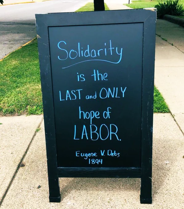 Sandwich board reads “Solidarity is the last and only hoppy of labor. Eugene V. Debs 1894”