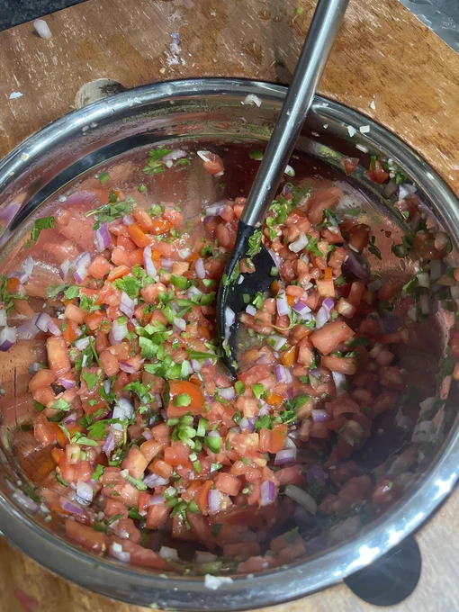 Cilantro tomato jalapeño red onion diced in a bowl