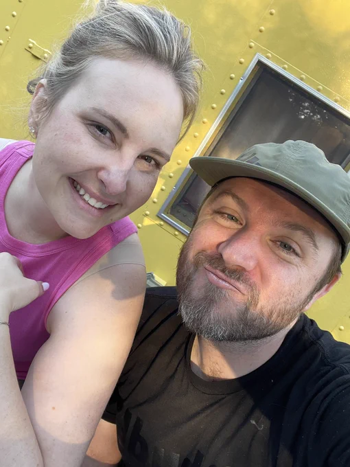 Mandy wearing a pink tank top and Tyler in a black shirt and green hat.