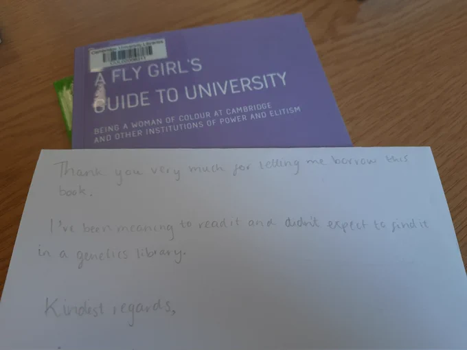 A book entitled 'A Fly Girl's Guide to University' with a note on top saying 'Thank you very much for letting me borrow this book. I've been meaning to read it and didn't expect to find it in a genetics library'.