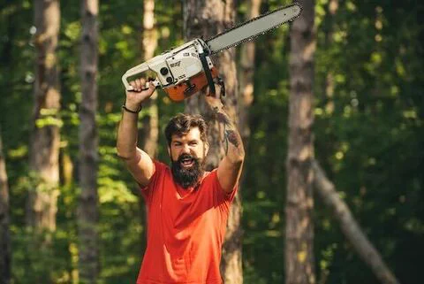 A bearded man, wielding a chainsaw