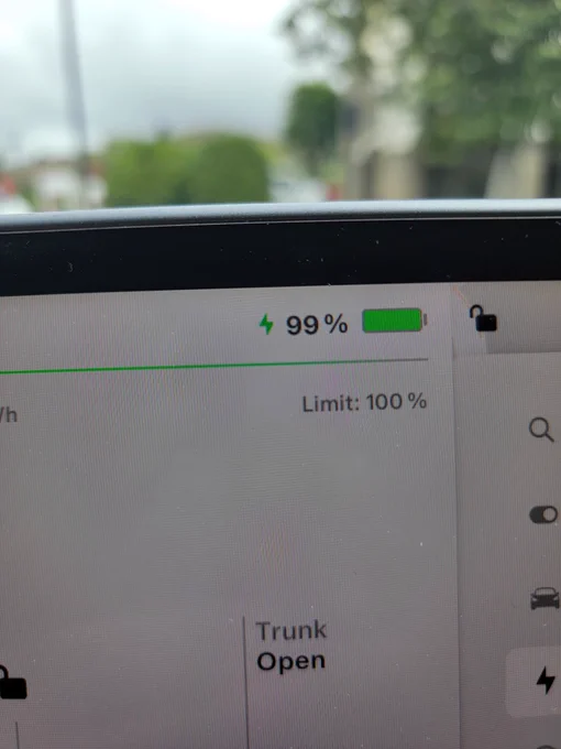 Screen in Tesla showing Ninety Nine percent charged.