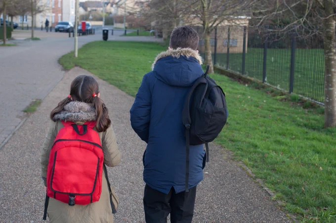 Boy and girl walk to school