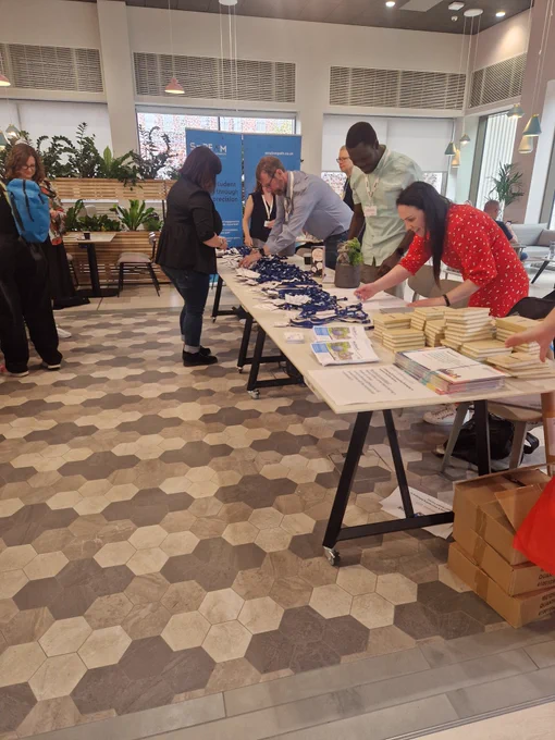 Registration Table at RAISE Conference 2023 with delegates registering