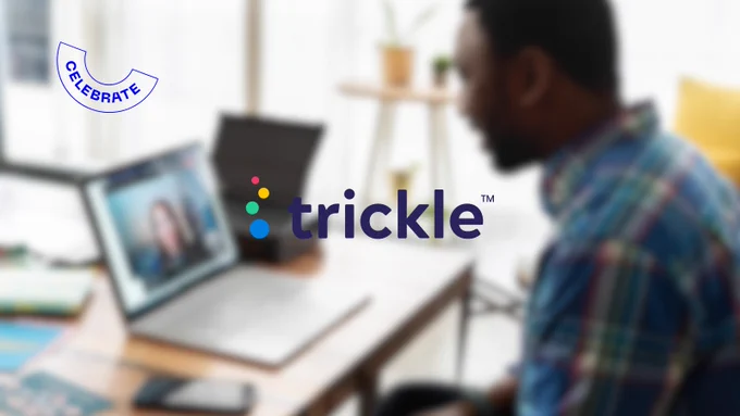 Blue text logo on a blurred background reading "Trickle". The background shows a side view of a man sitting at a desk with a computer. Text in left corner reading "celebrate".