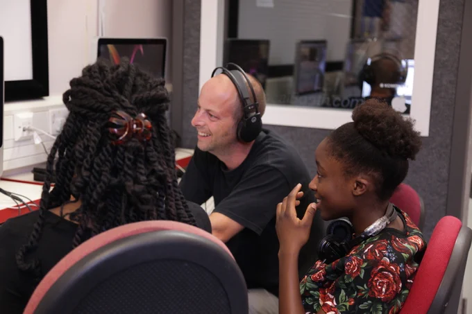 our senior librarian jamie hutchison showing two people how to use some of the technology at studio 12