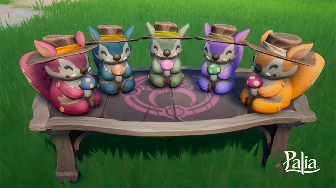 Five Chapaa plushies, sit on a table in a semicircle shape. The Palia logo can be seen in the bottom righthand corner of the image. 