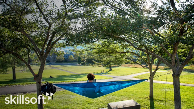 Student studying in a hammock on campus