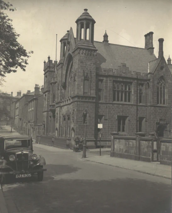 Monochrome image of Preston Grammar School. 1930s car is parked to the left