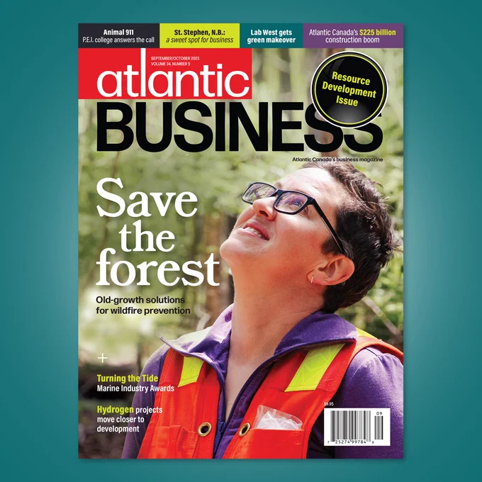 Magazine cover featuring a woman with short dark hair and glasses smiling and tilting her head upwards. She is wearing a purple shirt and a reflective orange vest. Text reads "Save the forest: old growth solutions for fire prevention"