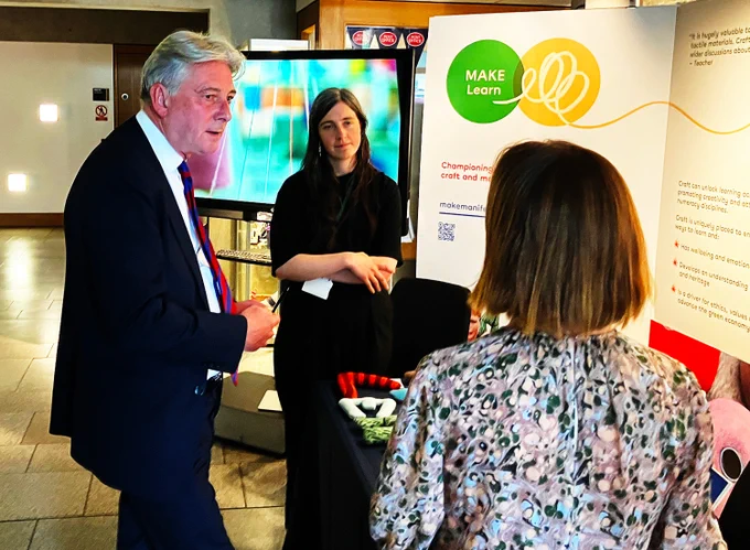 Photograph talking to staff on the Make Manifesto stand in the Scottish Parliament
