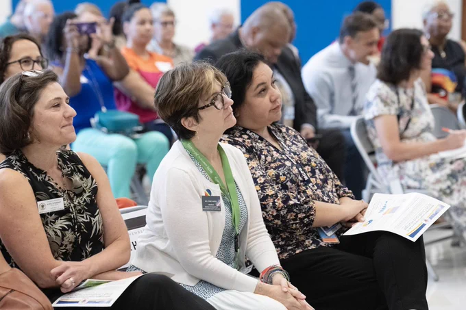 BOE members Lynne Harris and Grace Rivera-Oven listen in from the audience to the End Childhood Hunger press briefing presented by the Montgomery County Government.