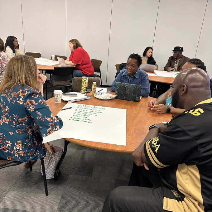 Photo of people sitting at tables having discussions.