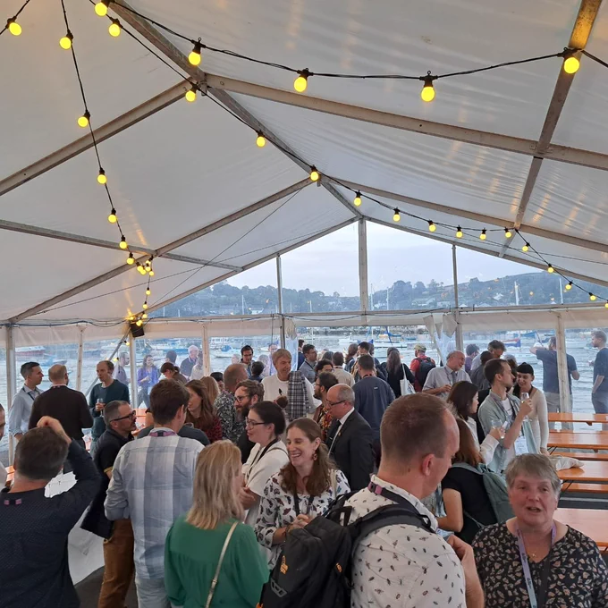 Entomologists mingling at the Ento23 conference dinner with view of the harbour out the back windows (Greenbank Hotel, Falmouth)