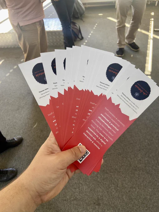 A stack of bookmarks in a hand