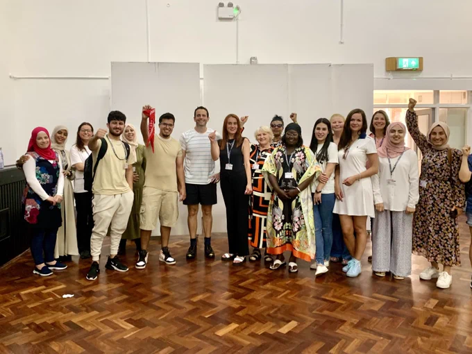 ESOL learners and Tudur smiling at the camera