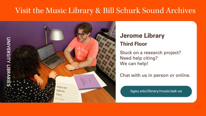 In a booth on the third floor of the library, a student is getting help from the head librarian with a music-related topic. The student is smiling.