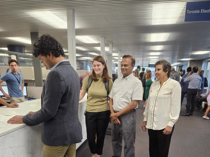 Kevin inside City Hall with his partner and parents, signing the paperwork to become a candidate in the Scarborough Southwest by-election taking place on November 30,  2023